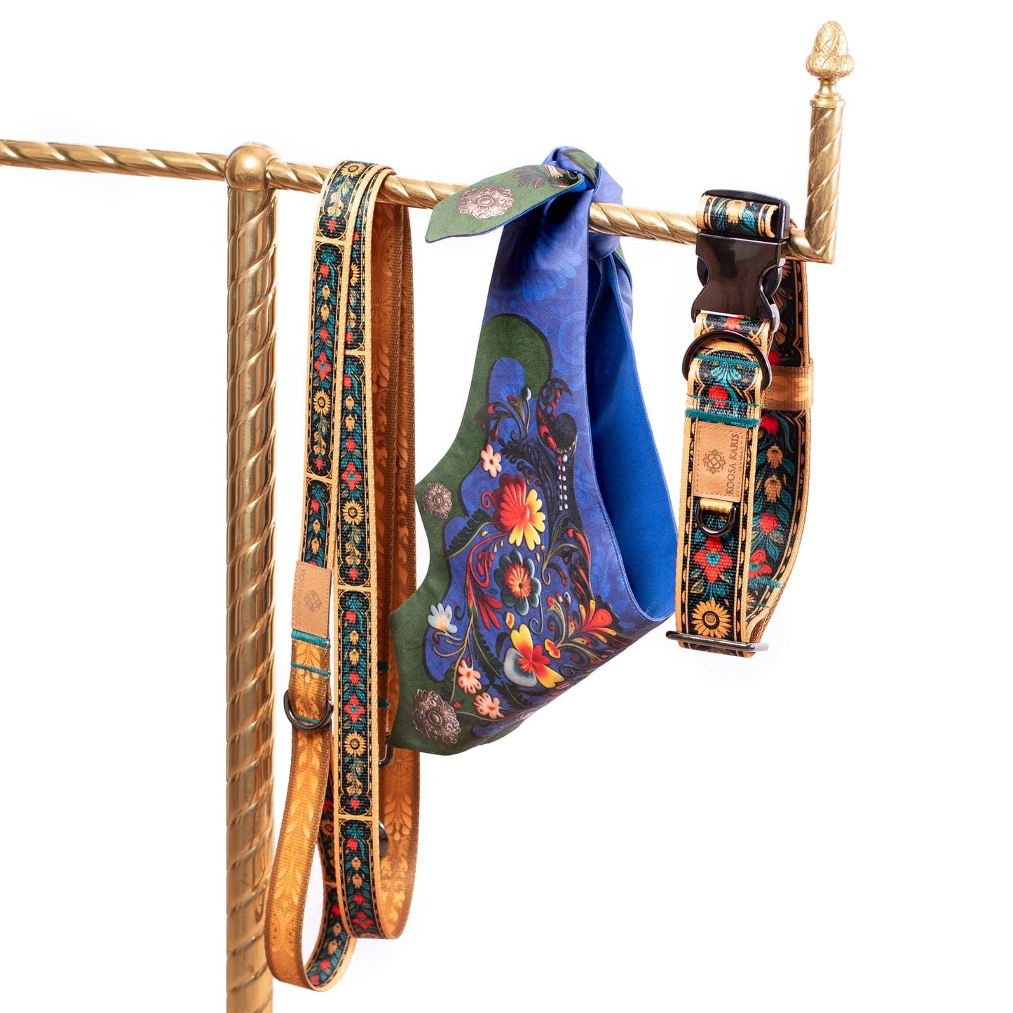 Gold dog collar and leash set with a colorful southwestern floral pattern along with a royal blue dog bandana with a vivid floral pattern 