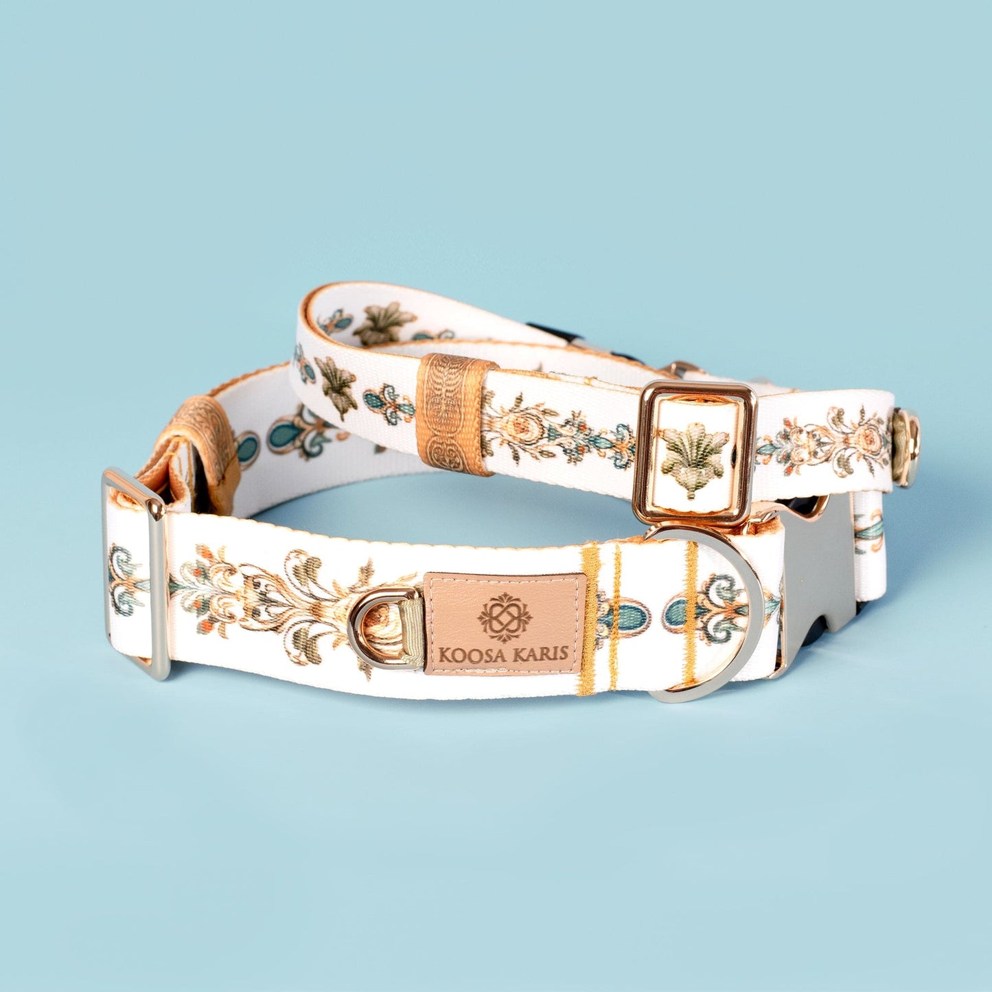 White and yellow dog collars with a green, yellow and teal fancy scroll pattern and gold-toned hardware 