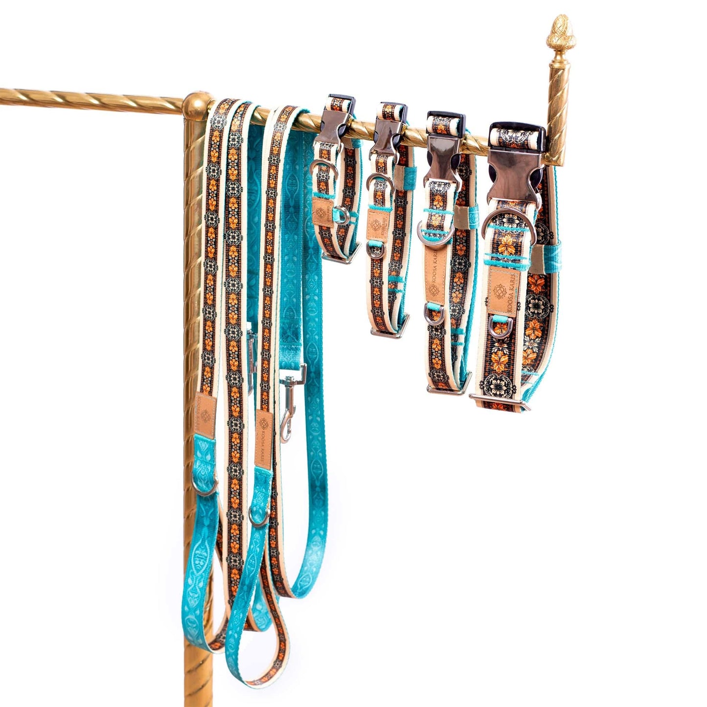 Ivory and turquoise colored dog collars and leashes with silver-toned hardware and a black and gold Western floral pattern 