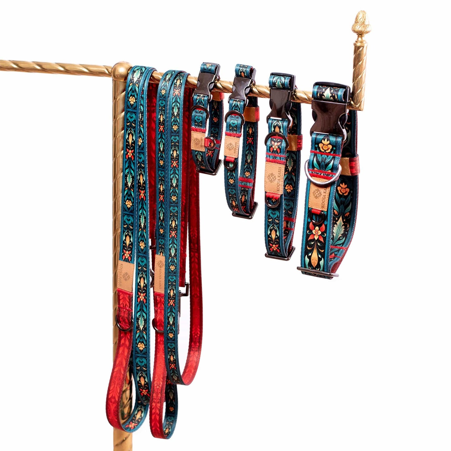 Cobalt blue dog collars and leashes with gunmetal-toned hardware and a colorful southwestern floral pattern 